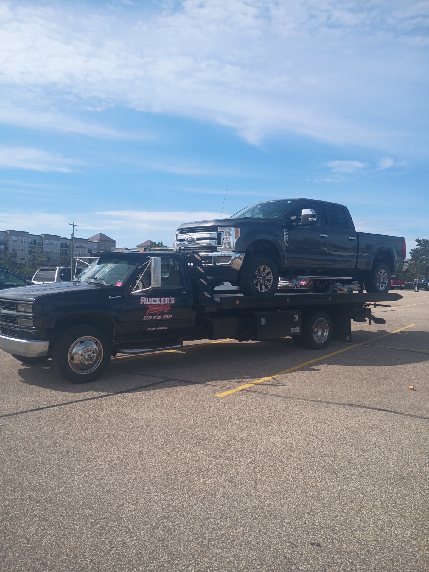 Ruckers Towing flatbed hauling a Ford Super Duty pickup